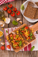 Rye bread withsweet corn, basil and tomato.