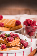 Waffles with raspberries and chocolate cream.