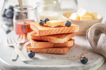 Homemade and sweet french toast with honey and fresh berries.