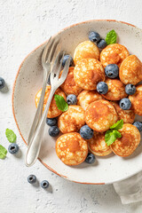 Tasty and hot poffertjes with fresh berries.