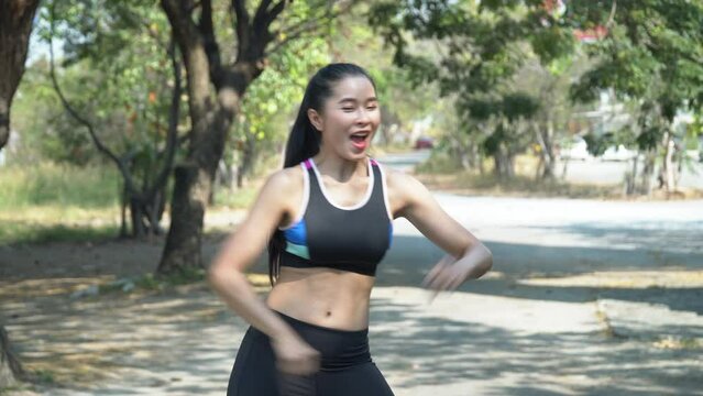 fit asian young women wearing sportswear dancing in front of smartphone camera show on video social media online . influencer fitness woman warm up to sport training in morning sharing on internet