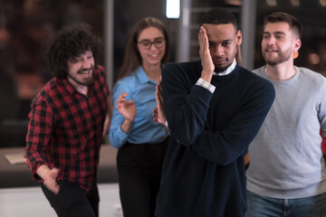 A group of young business people have fun playing interesting games while taking a break from work in a modern office. Selective focus 