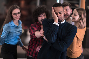 A group of young business people have fun playing interesting games while taking a break from work in a modern office. Selective focus 