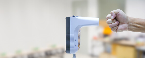 Hand with body measuring infrared thermometer for scan temperature palm of the hand check for personal screening fever test of coronavirus protection or covid-19 prevention