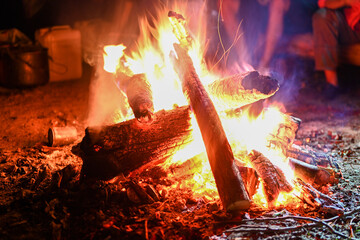Flames from a bonfire at night. Adventure traveling lifestyle. Concept wanderlust. Active weekend...