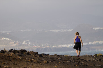 Woman walking in El Confital. La Isleta Protected Landscape. Las Palmas de Gran Canaria. Gran Canaria. Canary Islands. Spain.