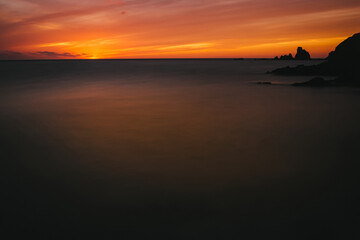 dramatic sunset seascape in silhouette. Hazy mediterranean sea in Cabo de Gata. Fire in the sky. Amazing colours- Travel. Peaceful.