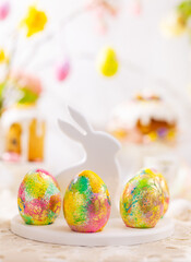 Easter composition with colorful Easter eggs on rabbit dessert plate. Traditional Easter treat