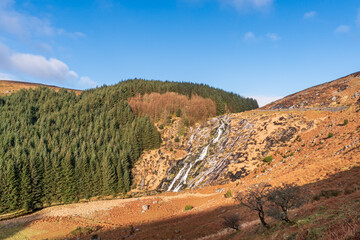 Glenmacnass Waterfall landscape in Wicklow, Ireland on a sunny spring morning.