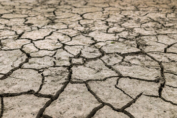 Lake drying out by lack of water. Big cracks in the ground.
Environmental changes due to climate change and global warming. 