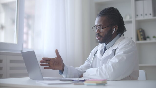 Enthusiastic Black Doctor Consulting Patient Via Video Chat, Online Check-up