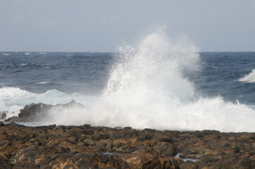 Fototapeta na wymiar Wave breaking against the shore. El Confital. La Isleta Protected Landscape. Las Palmas de Gran Canaria. Gran Canaria. Canary Islands. Spain.