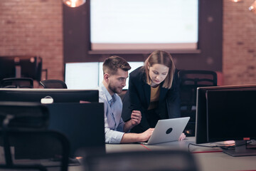  Smiling businesswoman experienced in work on business project training coaching man coworker,...