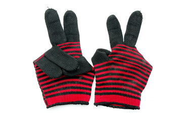 The victory sign shown by old fabric knitted gloves on white background