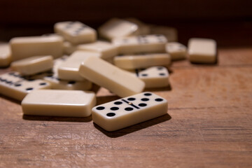 pile of dominos on a worn woden table