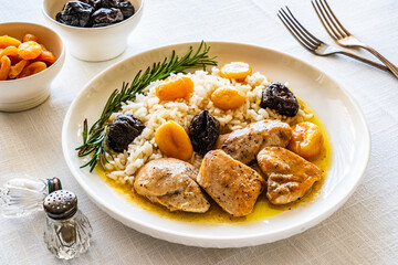 Chicken nuggets with rice, plums and apricots on white table
 - obrazy, fototapety, plakaty
