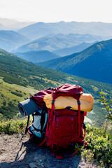 Backpack, sleeping mat in the mountains. Tourist equipment. Mountain landscape. Hiking in the mountains