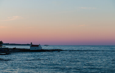 small chapel against the backdrop of sunset on the sea, Crete