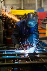 A welder works at a factory