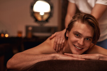Obraz na płótnie Canvas Masseur doing massage of male client in spa salon