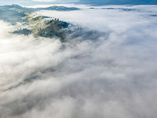 Morning mist in Ukrainian Carpathian mountains. Aerial drone view.