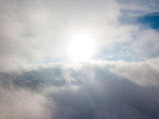 Naklejka na ściany i meble High flight above the clouds. Aerial drone view.