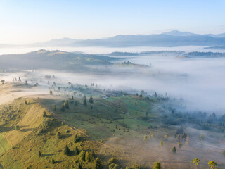 Green mountains of the Ukrainian Carpathians in the morning mist. Aerial drone view.