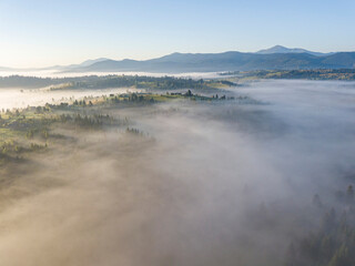 Obraz premium Morning fog in the Ukrainian Carpathians. Aerial drone view.