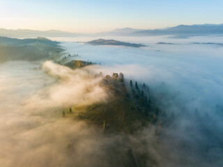 Morning mist in Ukrainian Carpathian mountains. Aerial drone view.