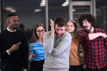 A group of young business people have fun playing interesting games while taking a break from work in a modern office. Selective focus 