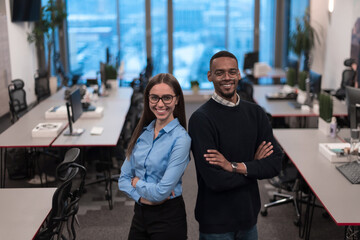Two happy diverse professional executive business team people woman and African American man looking at camera standing in office lobby hall. Multicultural company managers team portrait.