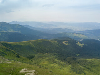 Fototapeta premium High mountains of the Ukrainian Carpathians in cloudy weather. Aerial drone view.