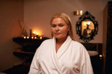 Serious caucasian girl look at camera in spa salon