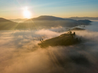 Sunrise over the fog in the Ukrainian Carpathians. Aerial drone view.