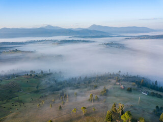 Green mountains of the Ukrainian Carpathians in the morning mist. Aerial drone view.
