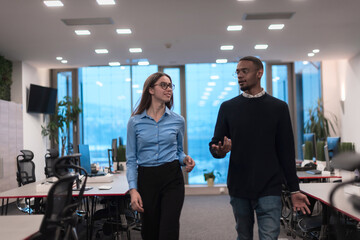 Two happy diverse professional executive business team people woman and African American man walking in coworking office. Multicultural company managers team portrait.