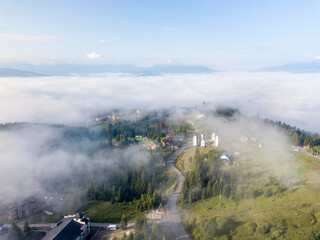 Fototapeta na wymiar Mountain settlement in the Ukrainian Carpathians in the morning mist. Aerial drone view.