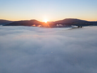 Sunrise over the fog in the Ukrainian Carpathians. Aerial drone view.