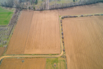 Agricultural fields plowed in spring, aerial view with rpa drone