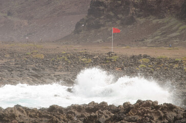 Flag prohibiting swimming in rough seas. El Confital. La Isleta Protected Landscape. Las Palmas de Gran Canaria. Gran Canaria. Canary Islands. Spain.