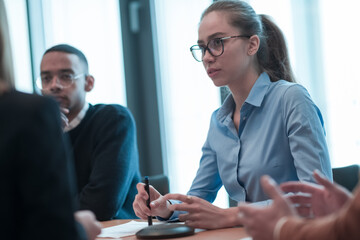 Successful team. Group of young multi-ethnic business people working and communicating together in creative office. Selective focus 