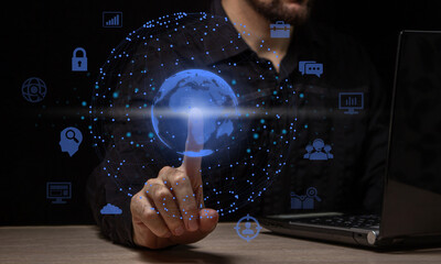 Fototapeta premium The businessman touches the projection of the planet. Concept of globality of customer network structure, data exchange connections, digital marketing, communication network and internet business.