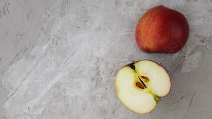 a cut apple on a concrete background. natural fruits . space for text.
