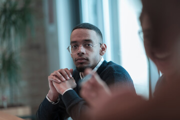 Successful team. Group of young multi-ethnic business people working and communicating together in creative office. Selective focus 