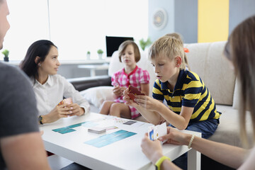 Fototapeta premium Children spend time with parents, mother entertain kids with games on holiday