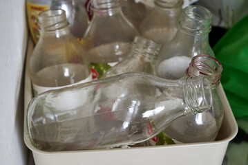 dirty, old, empty bottles in garbage segregation