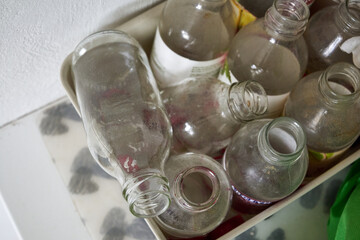 dirty, old, empty bottles in garbage segregation