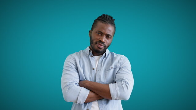 African-American man crossing arms on chest, tiring conversation, indifference