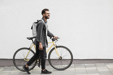 Handsome young man with bicycle in city, Smiling student men outdoor portrait, Active lifestyle, people, city life, having fun, casual business concept