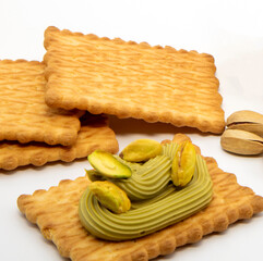 Breakfast biscuits with pistachio butter on white background.